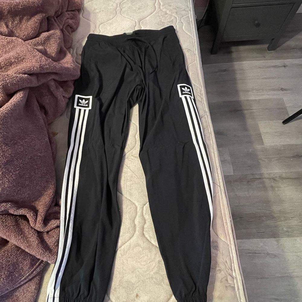 Men’s adidas track pants. Medium and made with 100% nylon, black
